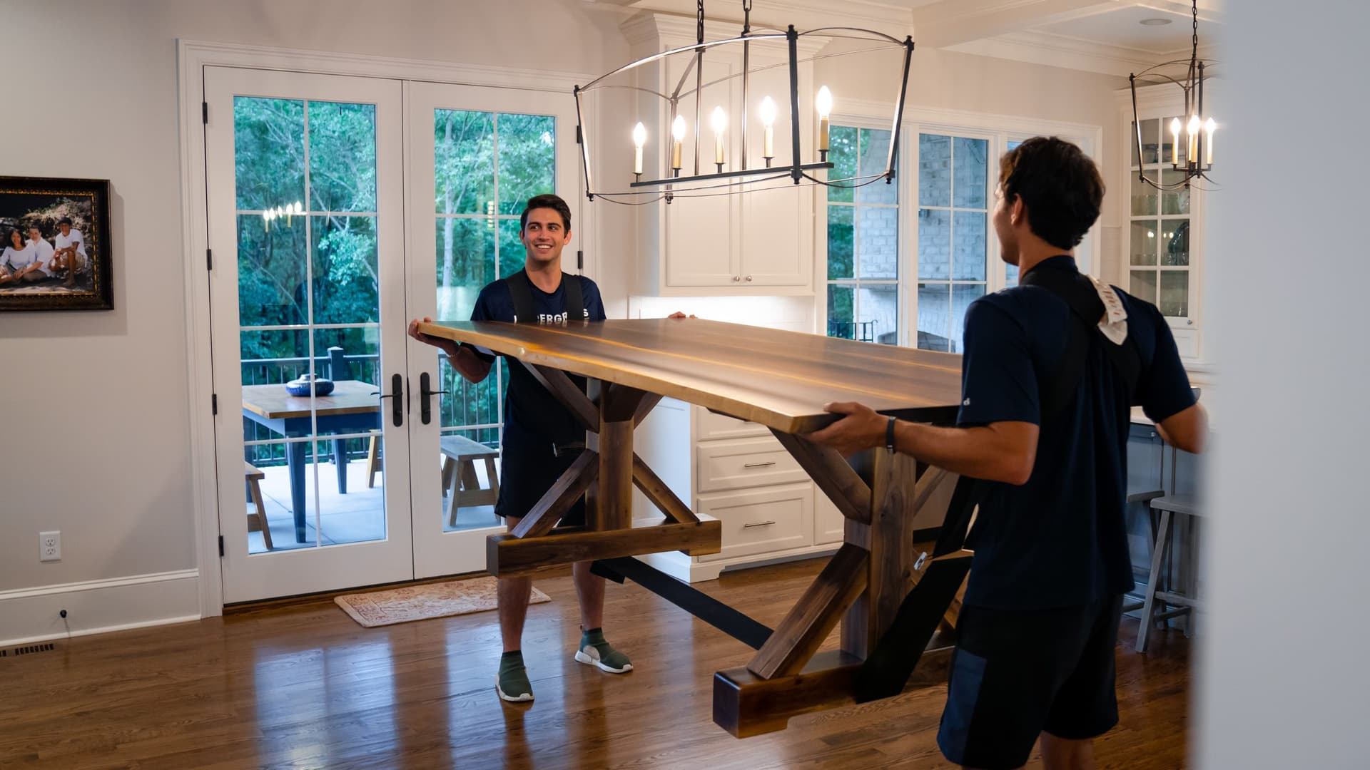 Undergrads crew rearranging furniture inside a home