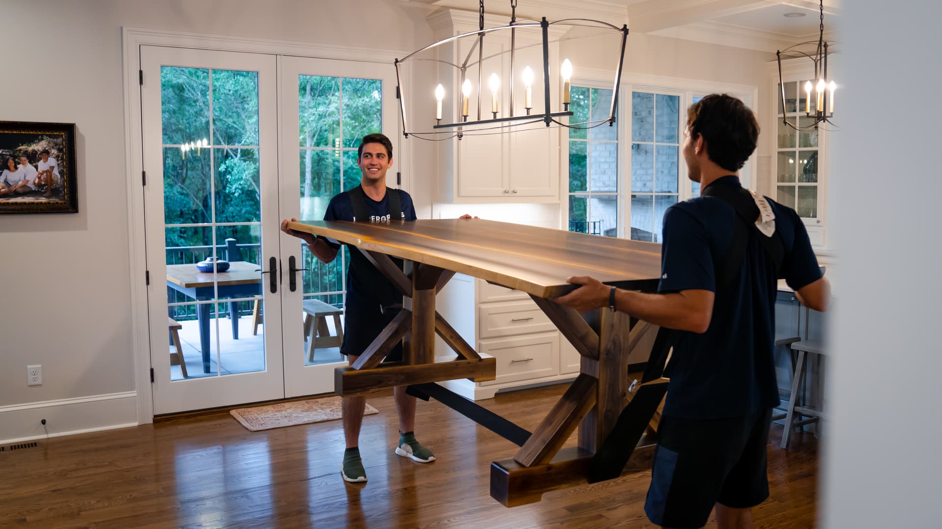 Undergrads crew rearranging furniture inside a home