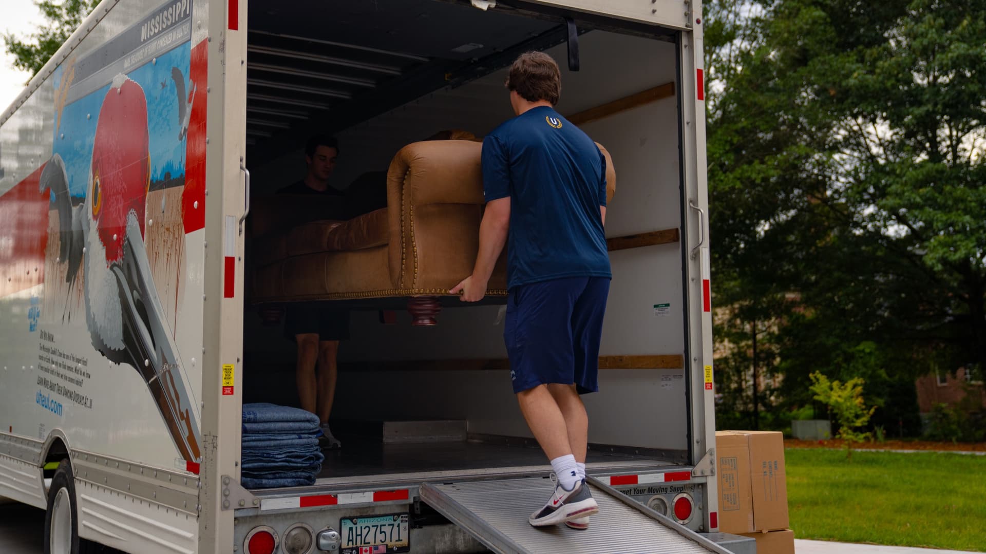 Undergrads crew loading furniture into a UHaul truck
